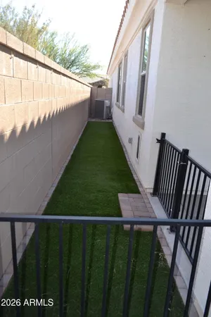 a view of a hallway with a walk in closet and a bathroom