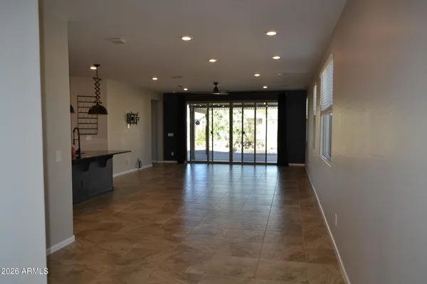 a view of a hallway with wooden floor and windows