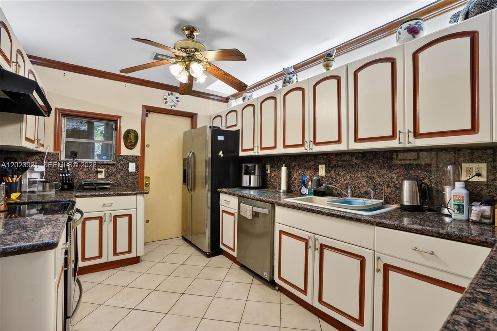 8461 Southwest 68th St Road Miami, FL 33143 - Photo 54 of 65 a kitchen with stainless steel appliances granite countertop a refrigerator and white cabinets