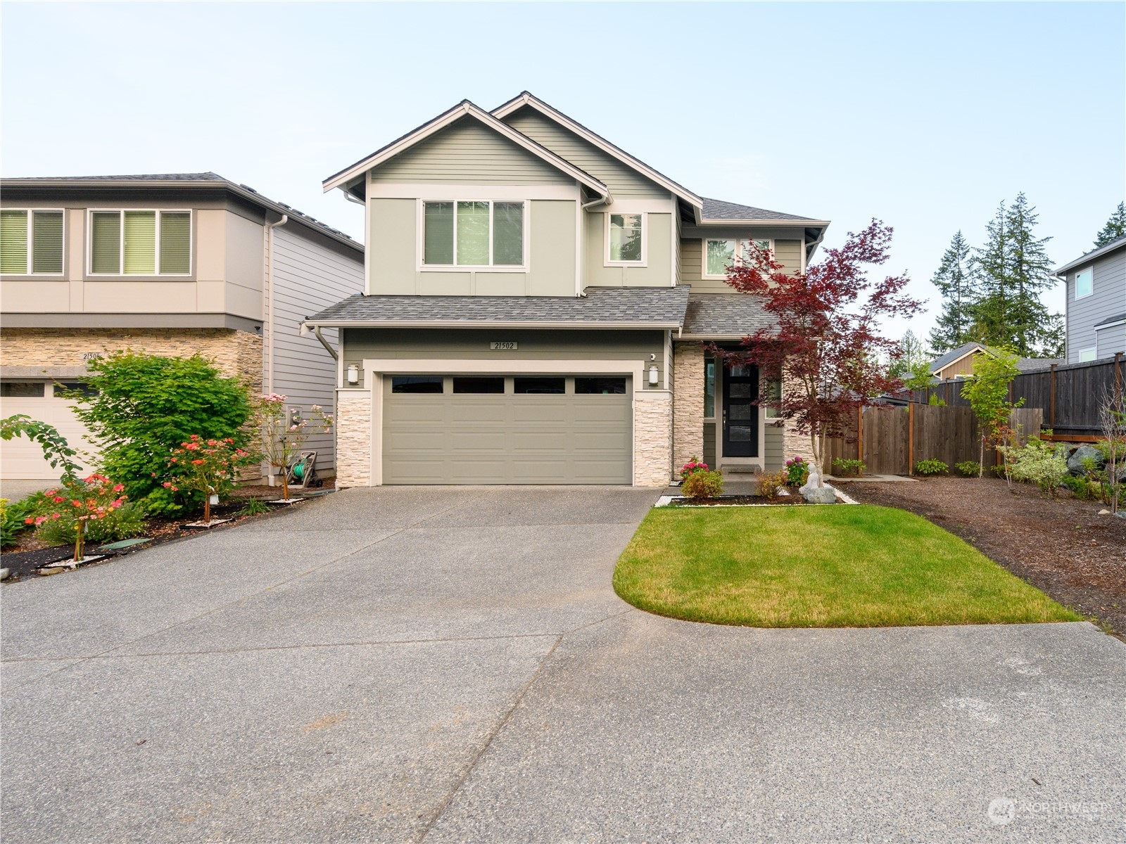 21502 44th Drive Southeast Bothell, WA 98021 - Photo 1 of 35 a front view of a house with a yard and garage