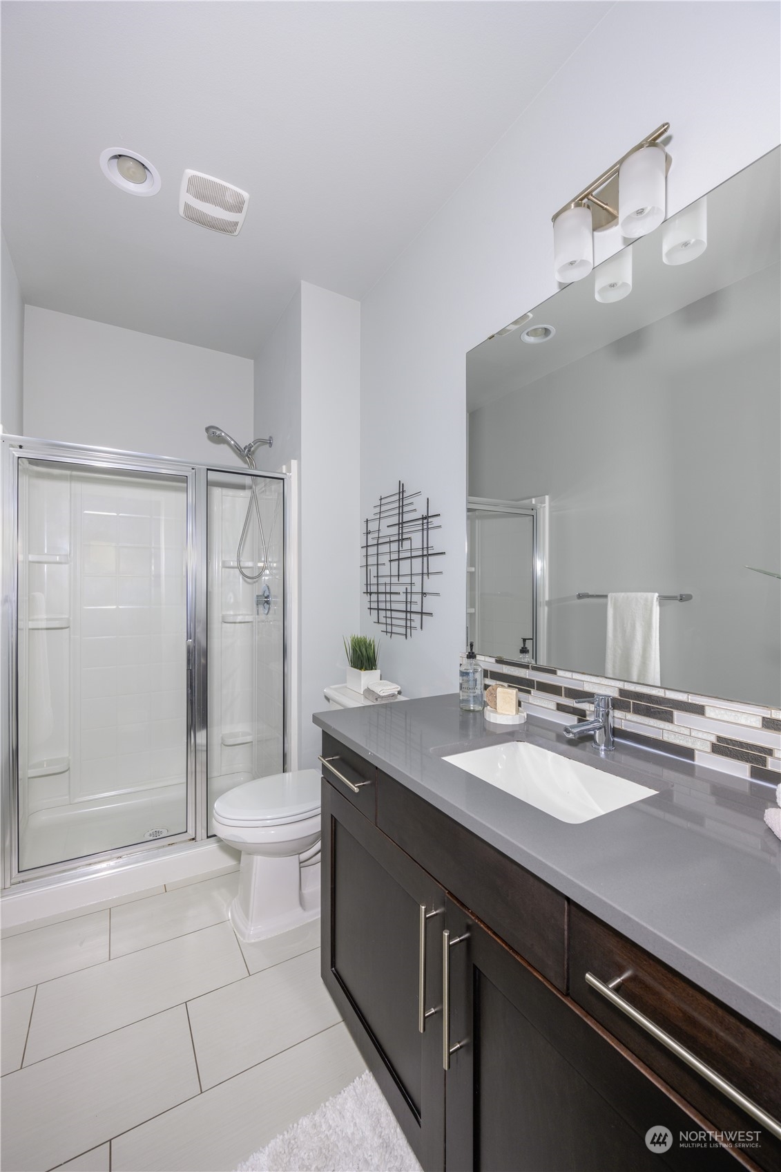 21502 44th Drive Southeast Bothell, WA 98021 - Photo 14 of 35 a bathroom with a granite countertop sink a toilet a mirror and shower