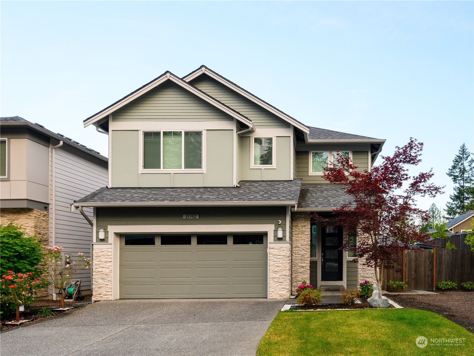 21502 44th Drive Southeast Bothell, WA 98021 - Photo 2 of 35 a front view of a house with a yard and garage