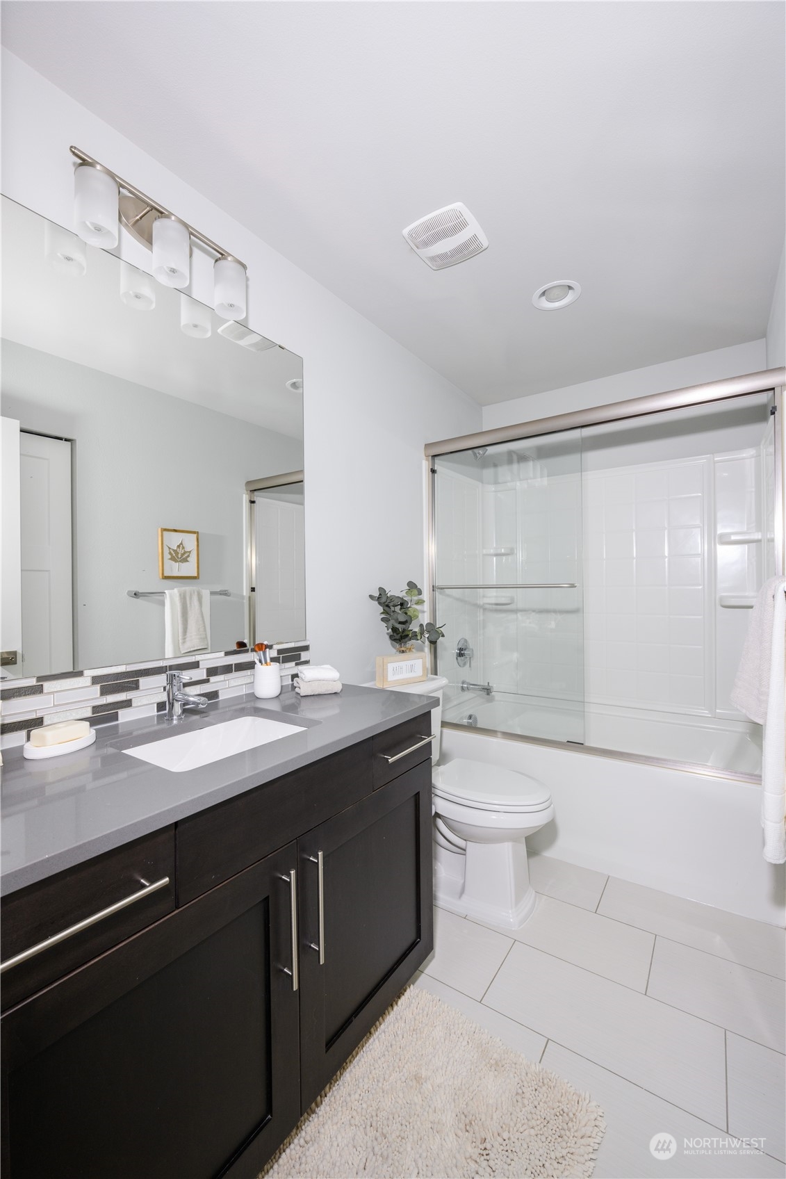 21502 44th Drive Southeast Bothell, WA 98021 - Photo 25 of 35 a bathroom with a granite countertop sink a toilet a mirror and shower