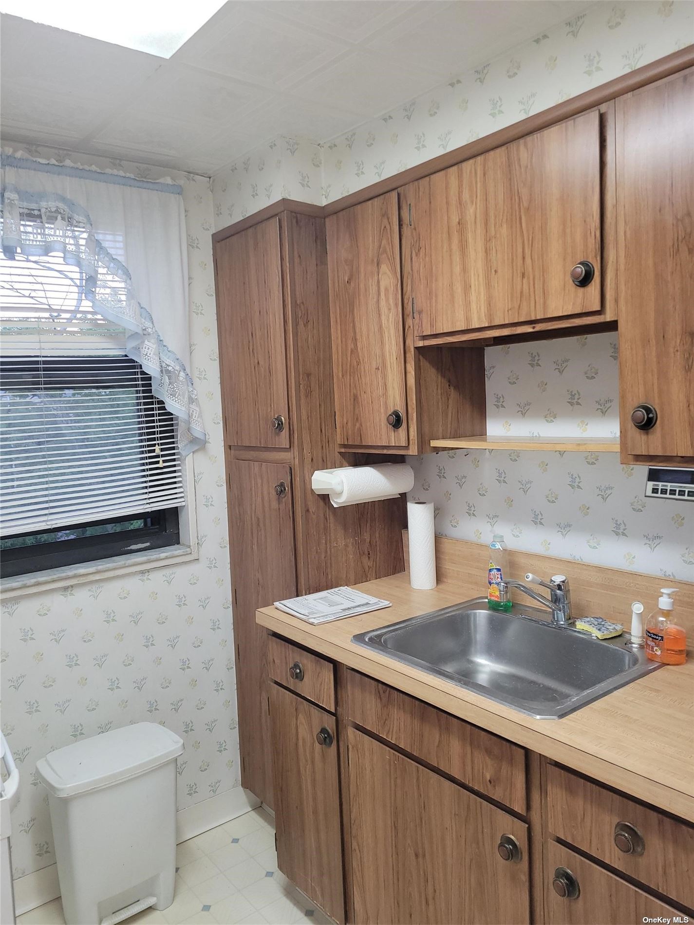 a kitchen with a sink cabinets and utility
