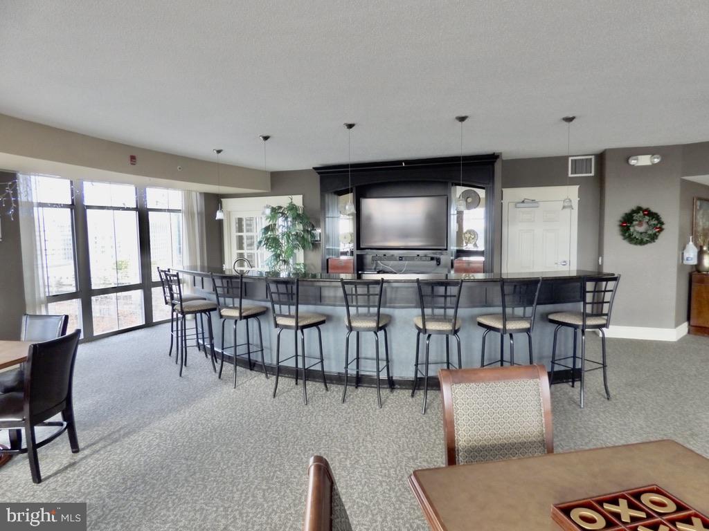 11800 Sunset Hills Road, Unit 118 Reston, VA 20190 - Photo 45 of 52 Stylish communal lounge with bar area.