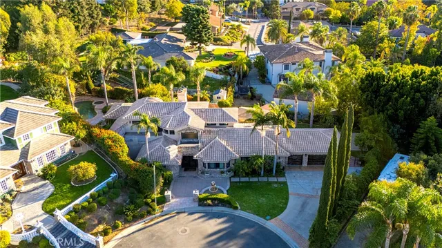 an aerial view of a house with a yard and garden