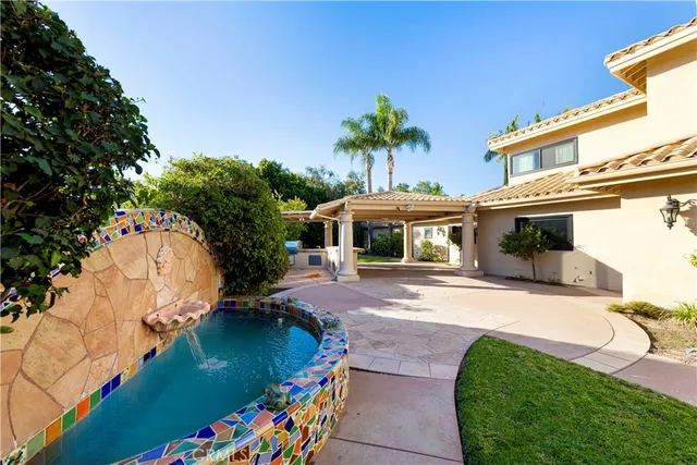 a living room with kitchen island granite countertop wooden floor and a large window