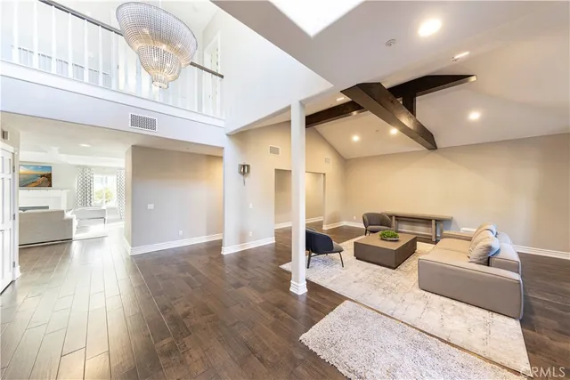 a large kitchen with a lot of counter space and wooden floor