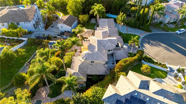 an aerial view of a house with swimming pool and garden view