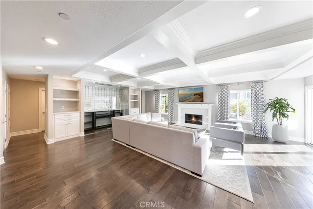 a view of a kitchen area with furniture and wooden floor