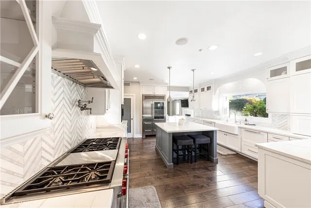 a kitchen with a sink cabinets and a window