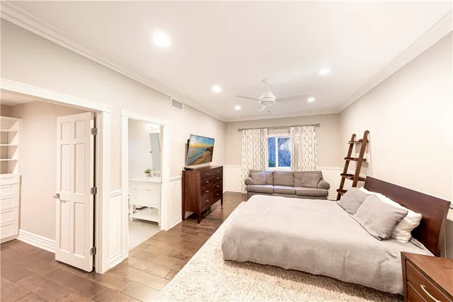 a living room with fireplace furniture wooden floor and a flat screen tv