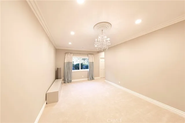 a living room with furniture a chandelier and a wooden floor
