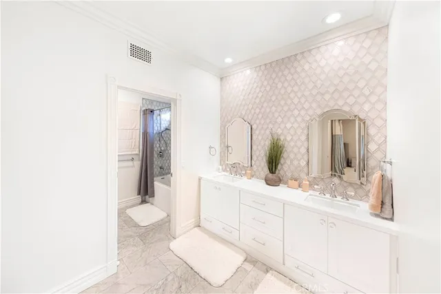 a bathroom with a toilet a sink and a mirror