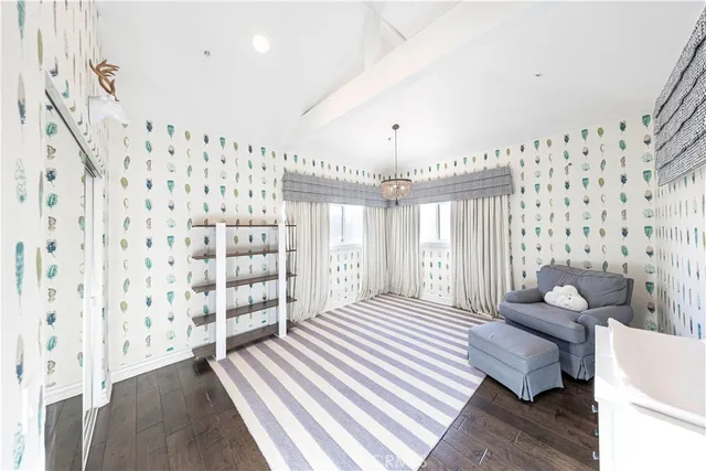 a large white kitchen with a large window and stainless steel appliances