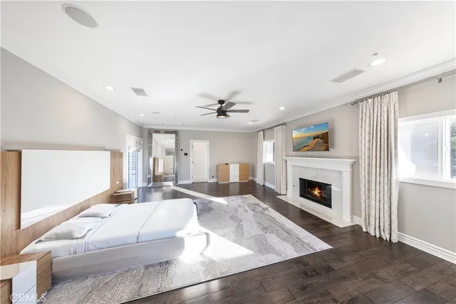 a view of a dining room and livingroom with furniture wooden floor a rug a chandelier