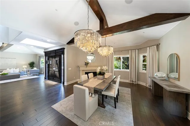 a kitchen with a table chairs refrigerator and microwave