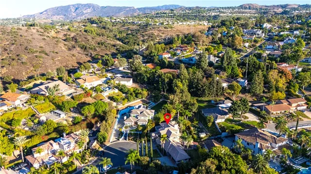 a view of a house with swimming pool and a small yard
