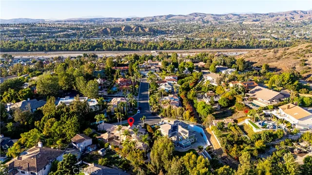 a view of a patio with a table and chairs under an umbrella