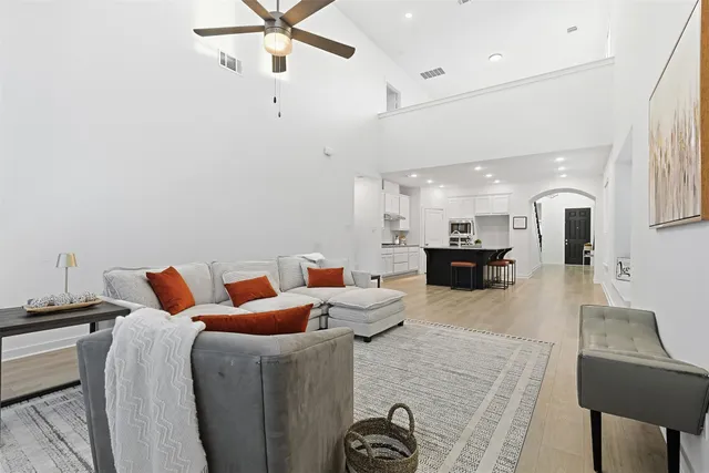 a living room with furniture a view of the kitchen