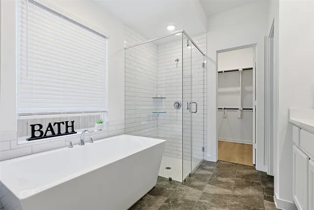 a bathroom with a bathtub and a shower