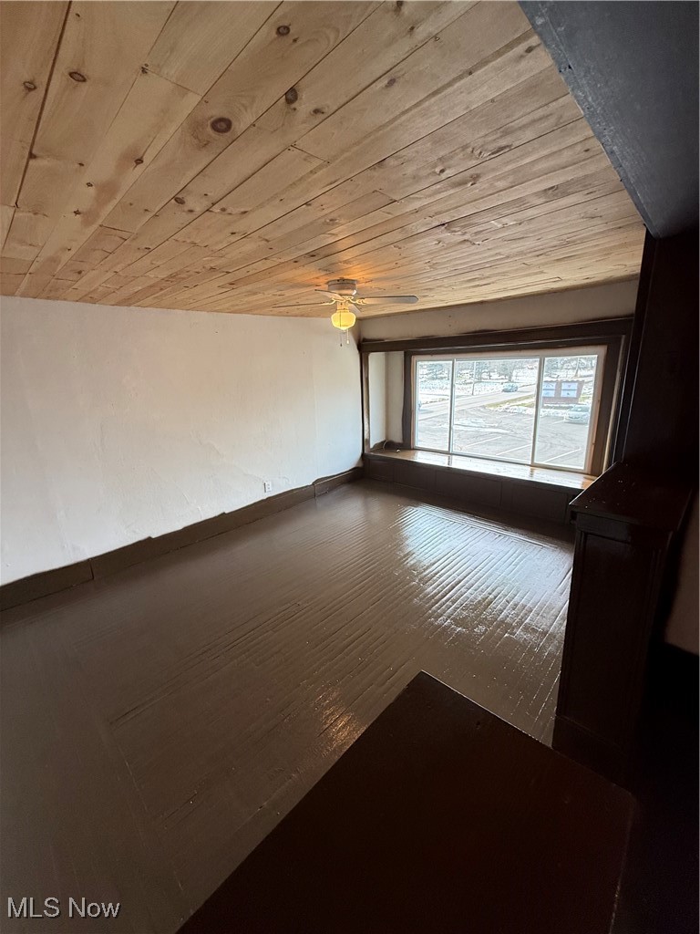 5037 Wilson Sharpsville Road, Unit 4 Fowler, OH 44418 - Photo 5 of 5 Unfurnished room with wood ceiling and wood finished floors