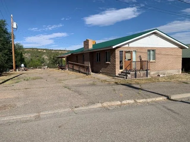 a view of a house with wooden fence