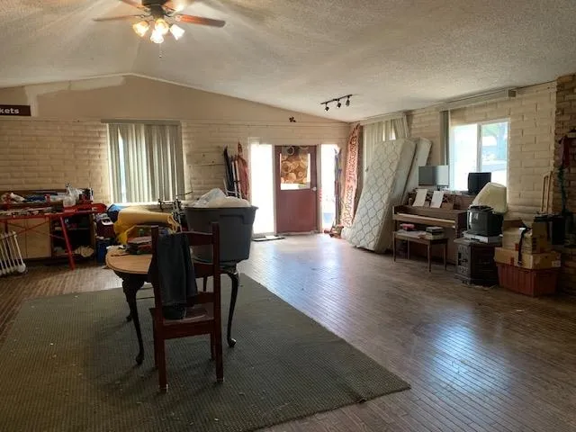 a view of a livingroom with furniture window and wooden floor