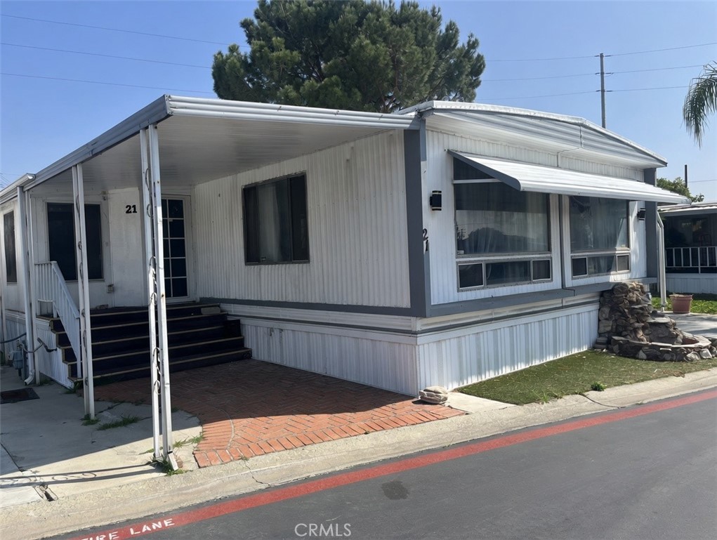 2930 West Rialto Avenue, Unit 21 Rialto, CA 92376 - Photo 1 of 5 a front view of a house with garage