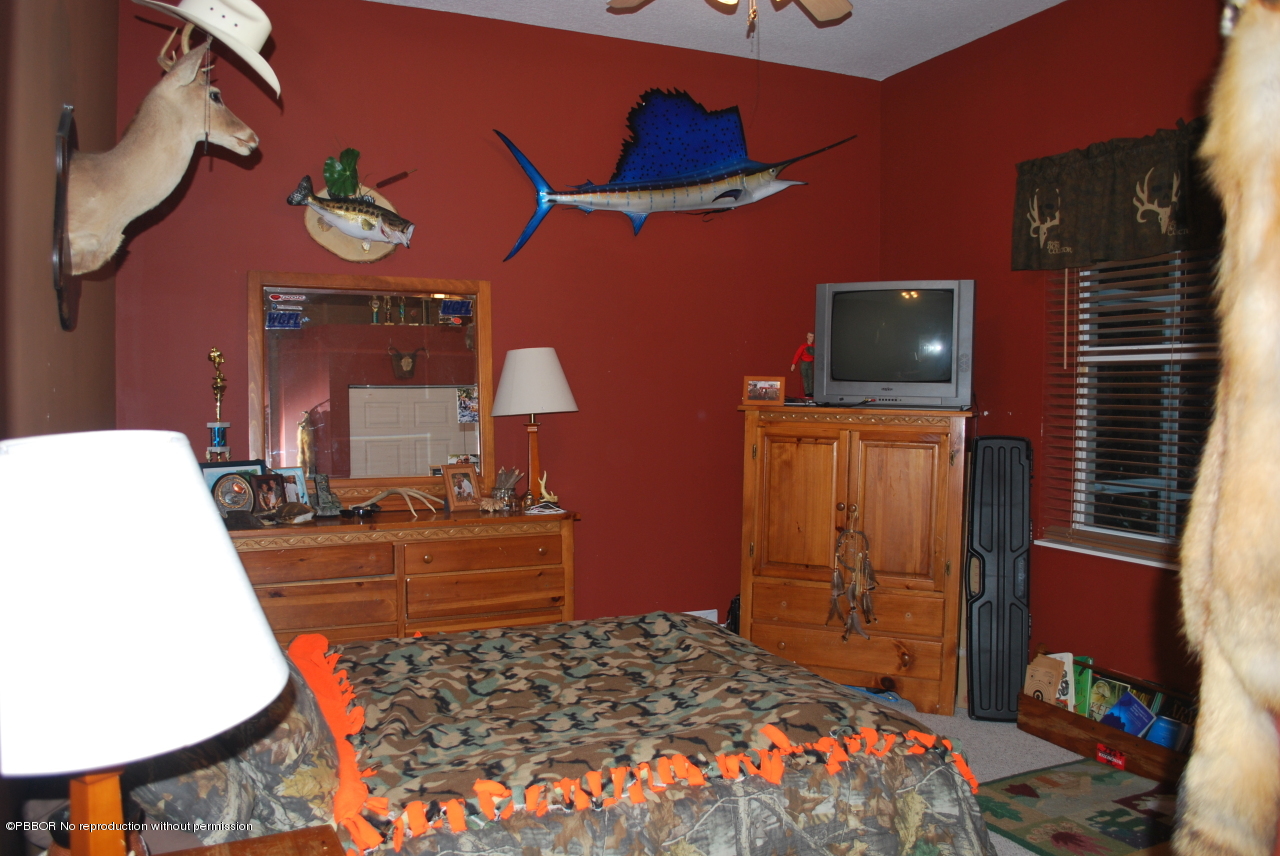 15920 Weatherly Road Wellington, FL 33414 - Photo 13 of 13 a bed room with a bed and a television