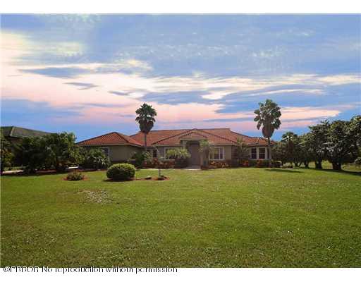 15920 Weatherly Road Wellington, FL 33414 - Photo 3 of 13 a view of a garden with a building in the background
