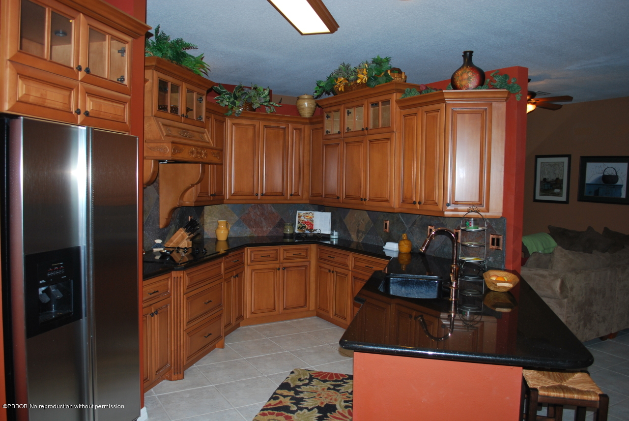 15920 Weatherly Road Wellington, FL 33414 - Photo 5 of 13 a kitchen with stainless steel appliances granite countertop a sink stove and refrigerator