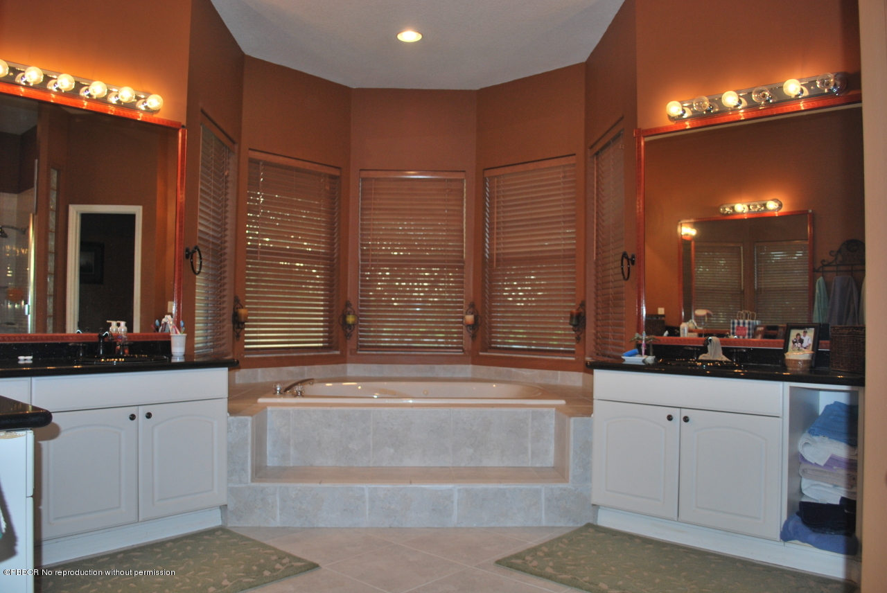 15920 Weatherly Road Wellington, FL 33414 - Photo 10 of 13 a large bathroom with a large tub and sink