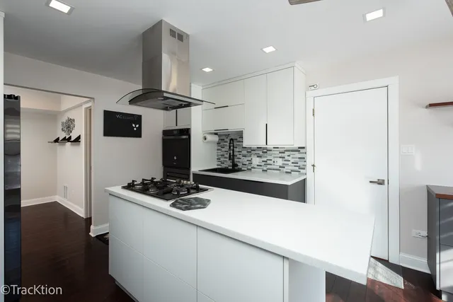 a kitchen with stainless steel appliances a refrigerator and a stove top oven