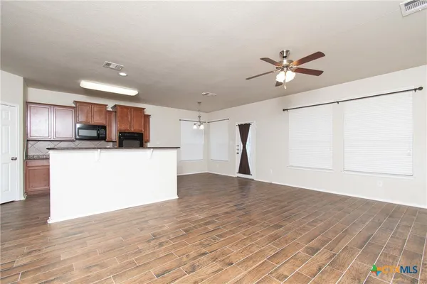 a view of a kitchen with a sink and a window
