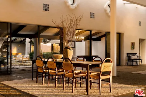 a building outdoor space with patio furniture and potted plants