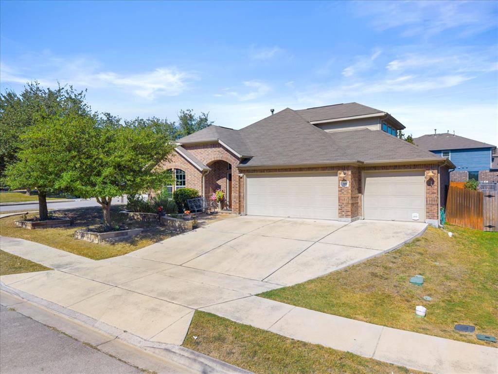 349 Razzmatazz Trail Buda, TX 78610 - Photo 1 of 27 An inviting brick home showcases a wide driveway and neatly maintained landscaping.