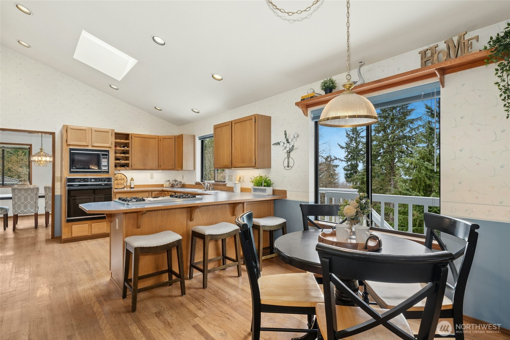 2420 Squak Mountain Loop Southwest Issaquah, WA 98027 - Photo 12 of 40 a dining room with furniture window and wooden floor