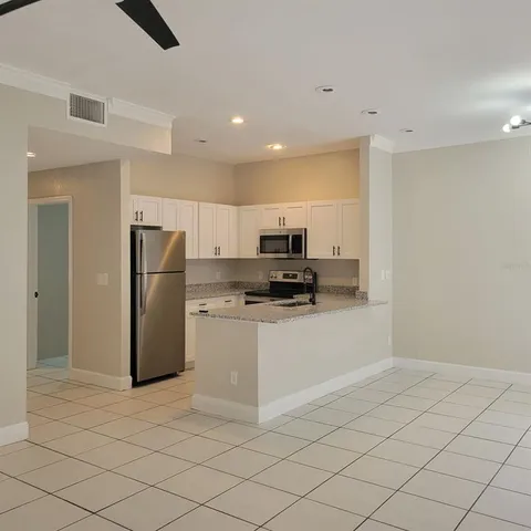 a kitchen with a refrigerator a stove a sink and a counter top space