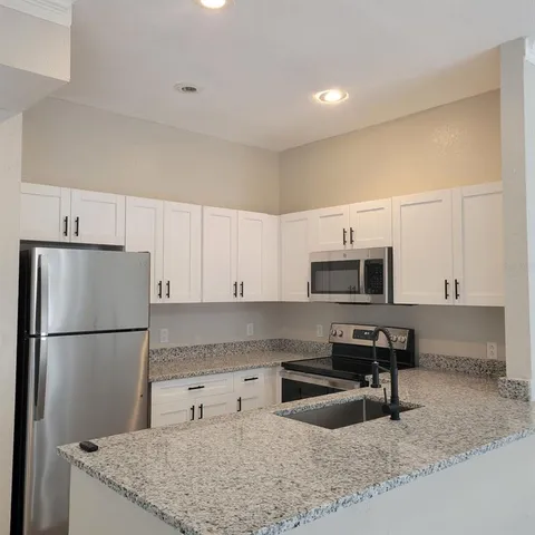 a white refrigerator freezer sitting in a kitchen
