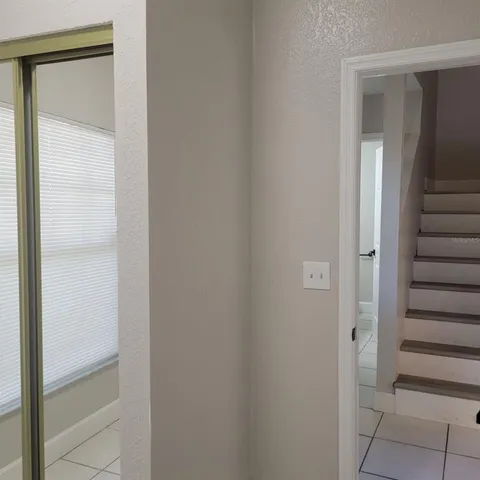 a bathroom with a granite countertop sink toilet and mirror