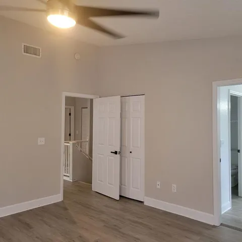 a view of an empty room with wooden floor