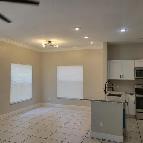 a view of kitchen with microwave and cabinets