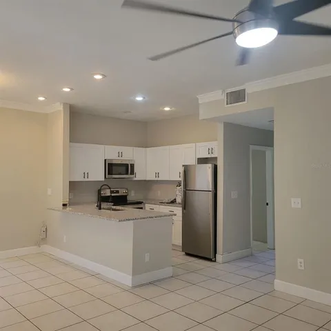 a kitchen with stainless steel appliances a refrigerator sink and microwave