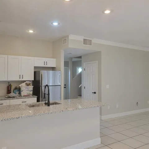 a kitchen with stainless steel appliances a refrigerator and a sink