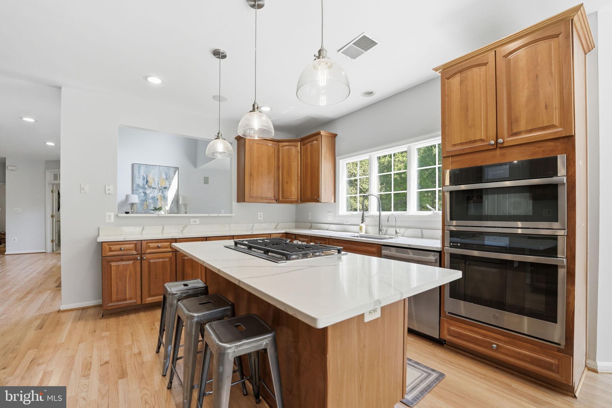 6075 Deer Ridge Trail Springfield, VA 22150 - Photo 15 of 61 a kitchen with a stove a sink and a refrigerator