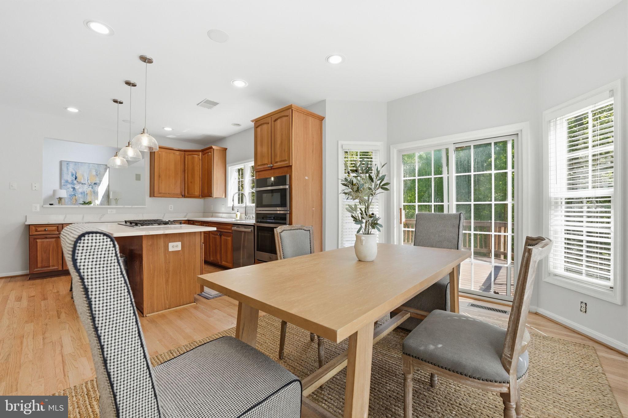6075 Deer Ridge Trail Springfield, VA 22150 - Photo 18 of 61 a view of a dining room with furniture and a kitchen