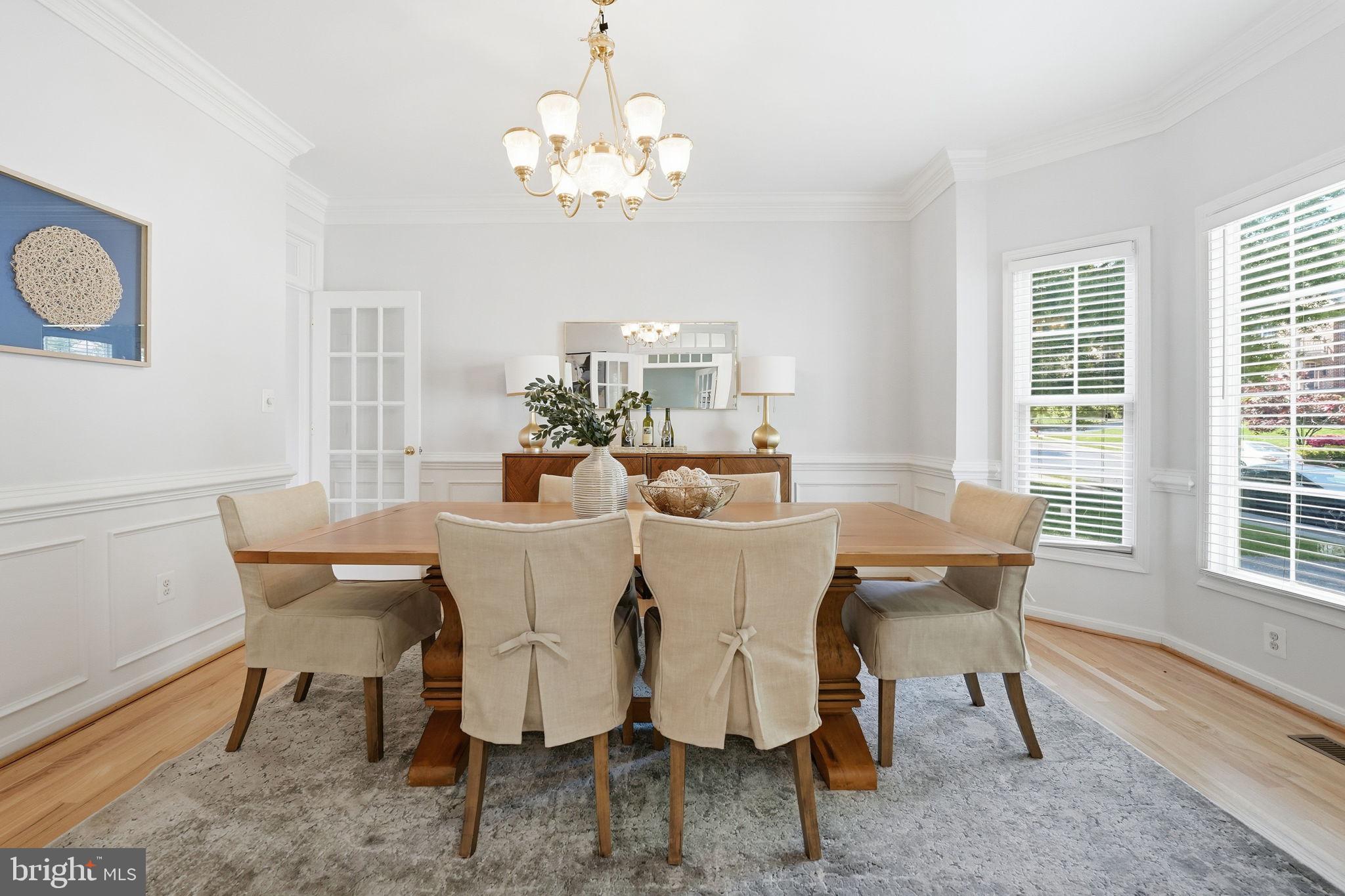 6075 Deer Ridge Trail Springfield, VA 22150 - Photo 19 of 61 a view of a dining room with furniture a chandelier and wooden floor