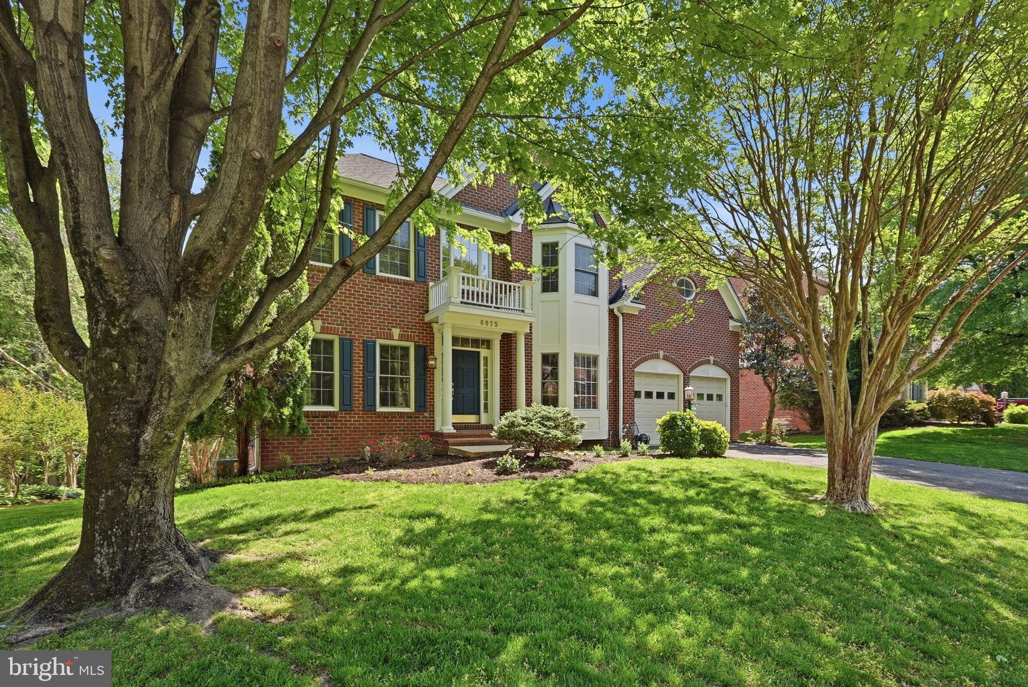 6075 Deer Ridge Trail Springfield, VA 22150 - Photo 2 of 61 a front view of a house with garden