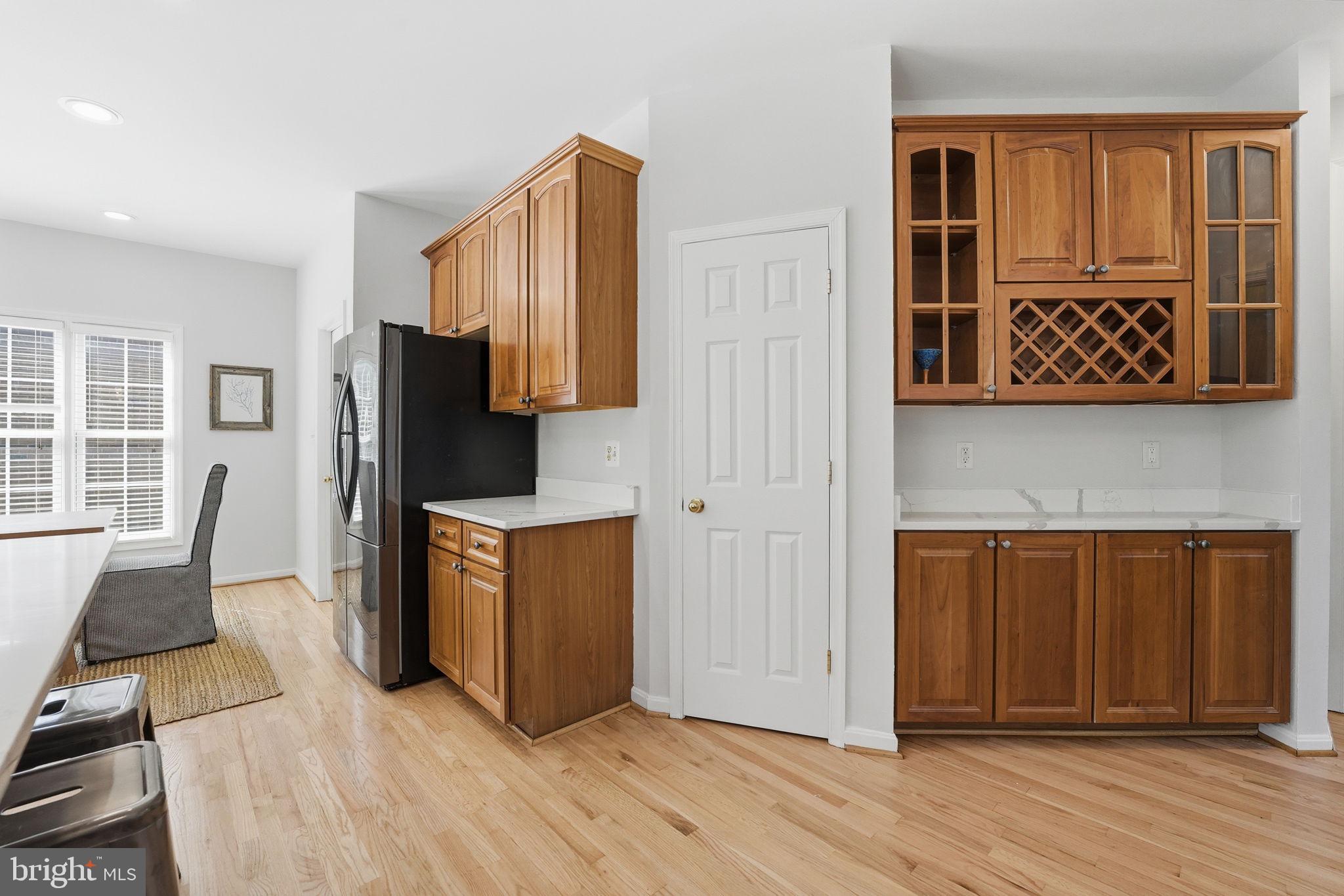 6075 Deer Ridge Trail Springfield, VA 22150 - Photo 23 of 61 a view of kitchen with stainless steel appliances wooden floor and chair